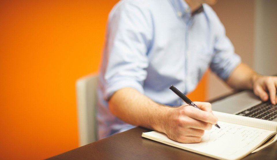 Person writing down the event budget